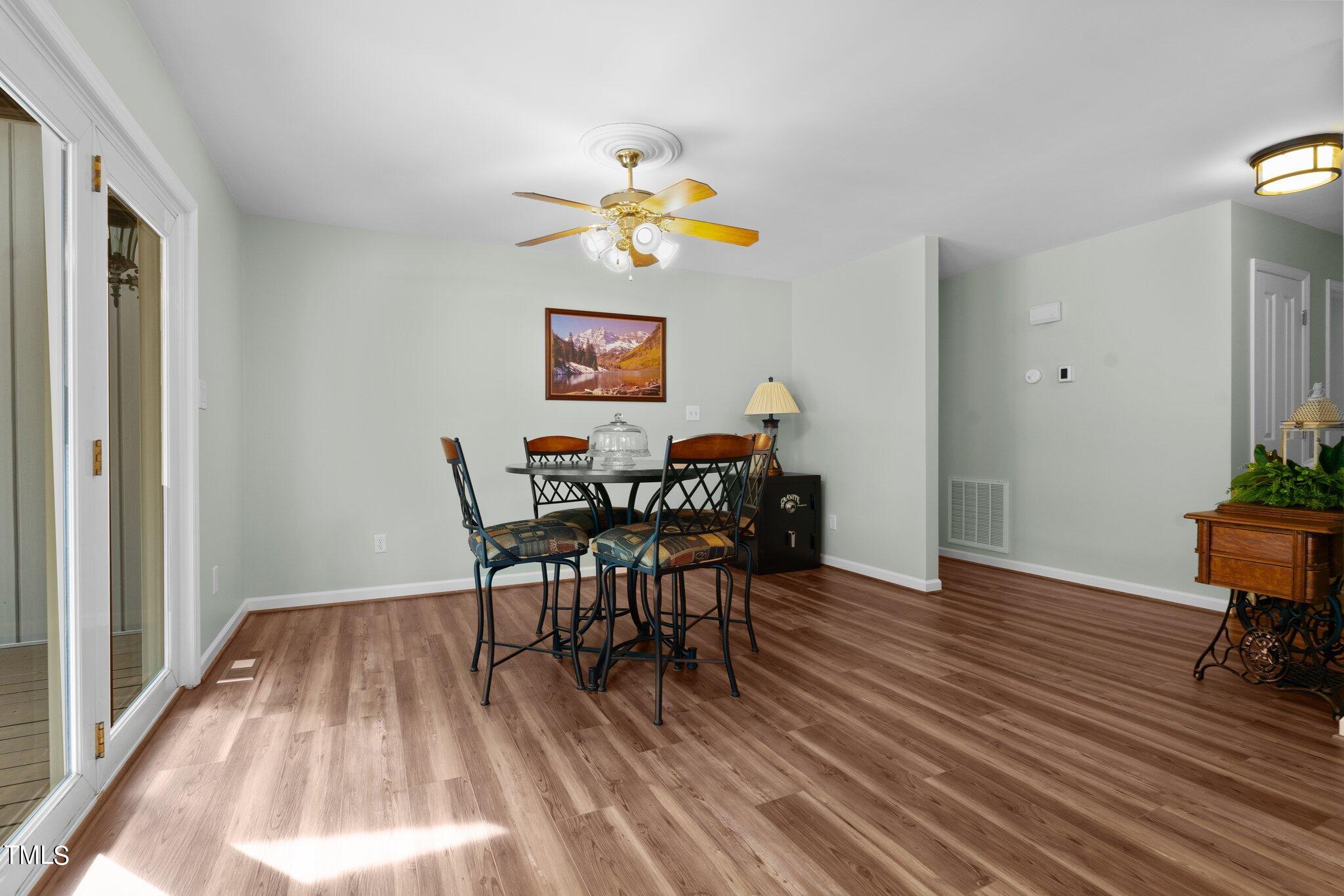 744 Alderman Mill Road Dunn, NC 28334 - Photo 14 of 50 a view of a dining room with furniture and wooden floor