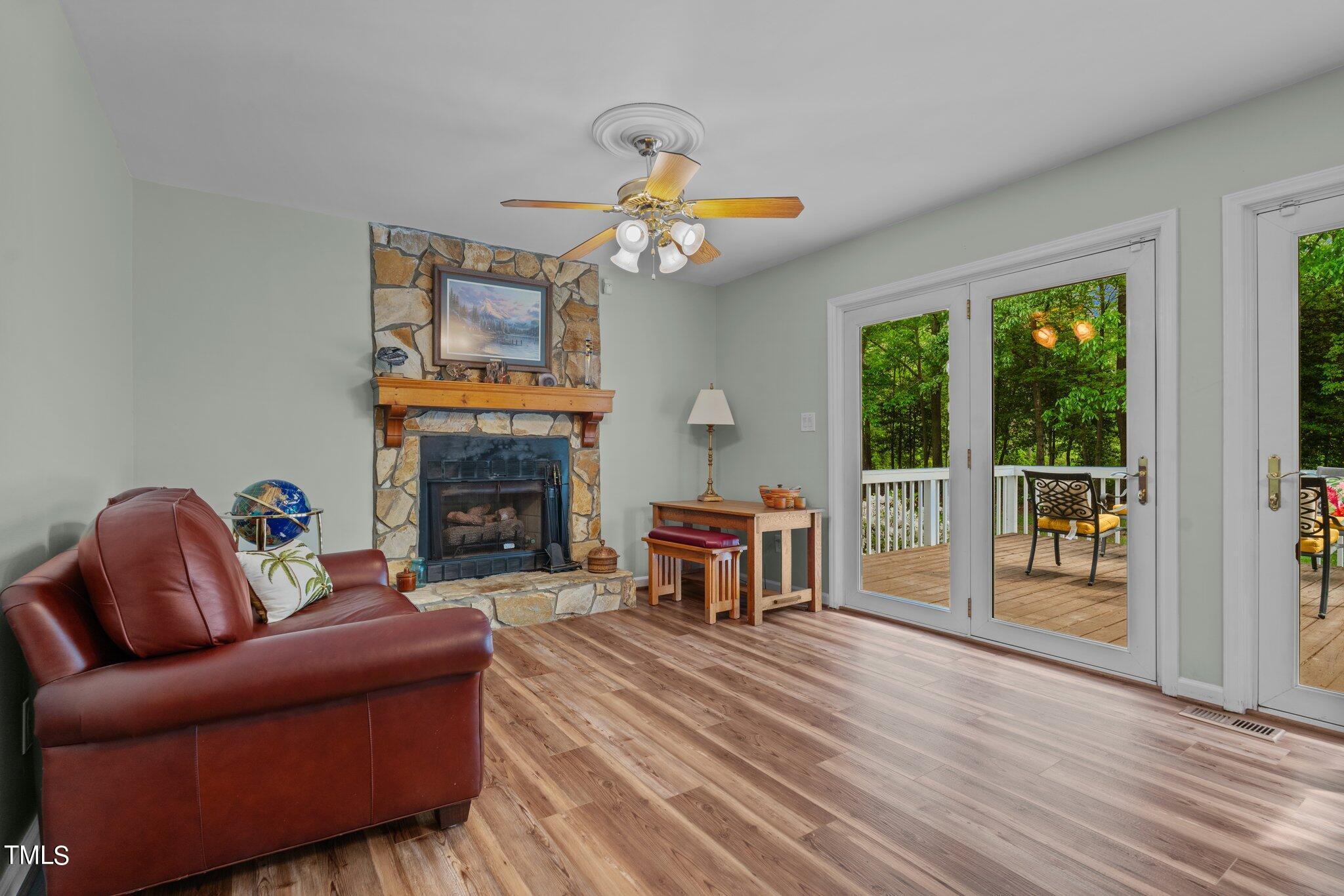 744 Alderman Mill Road Dunn, NC 28334 - Photo 15 of 50 a living room with furniture a fireplace and a flat screen tv