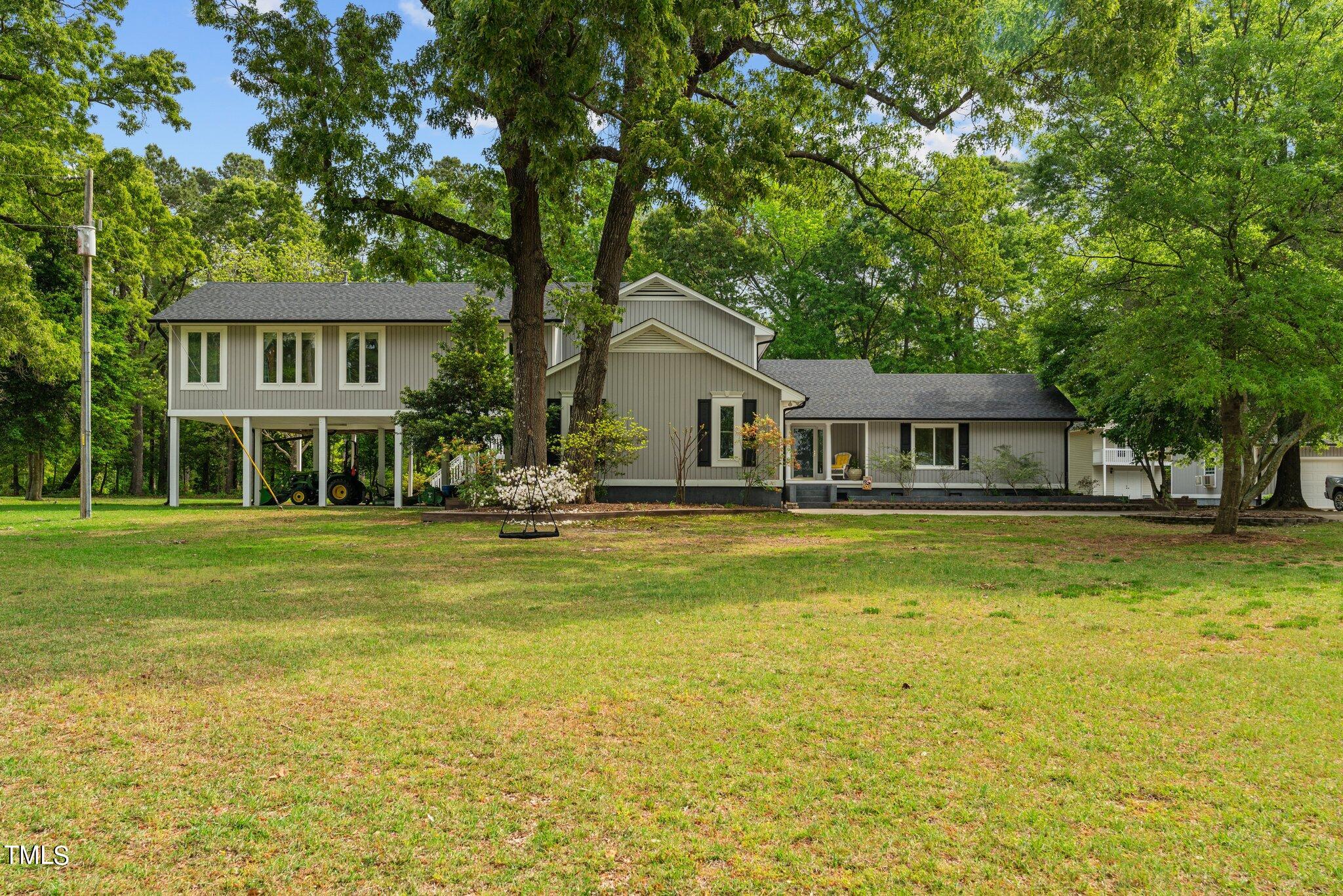 744 Alderman Mill Road Dunn, NC 28334 - Photo 3 of 50 a front view of a house with swimming pool having outdoor