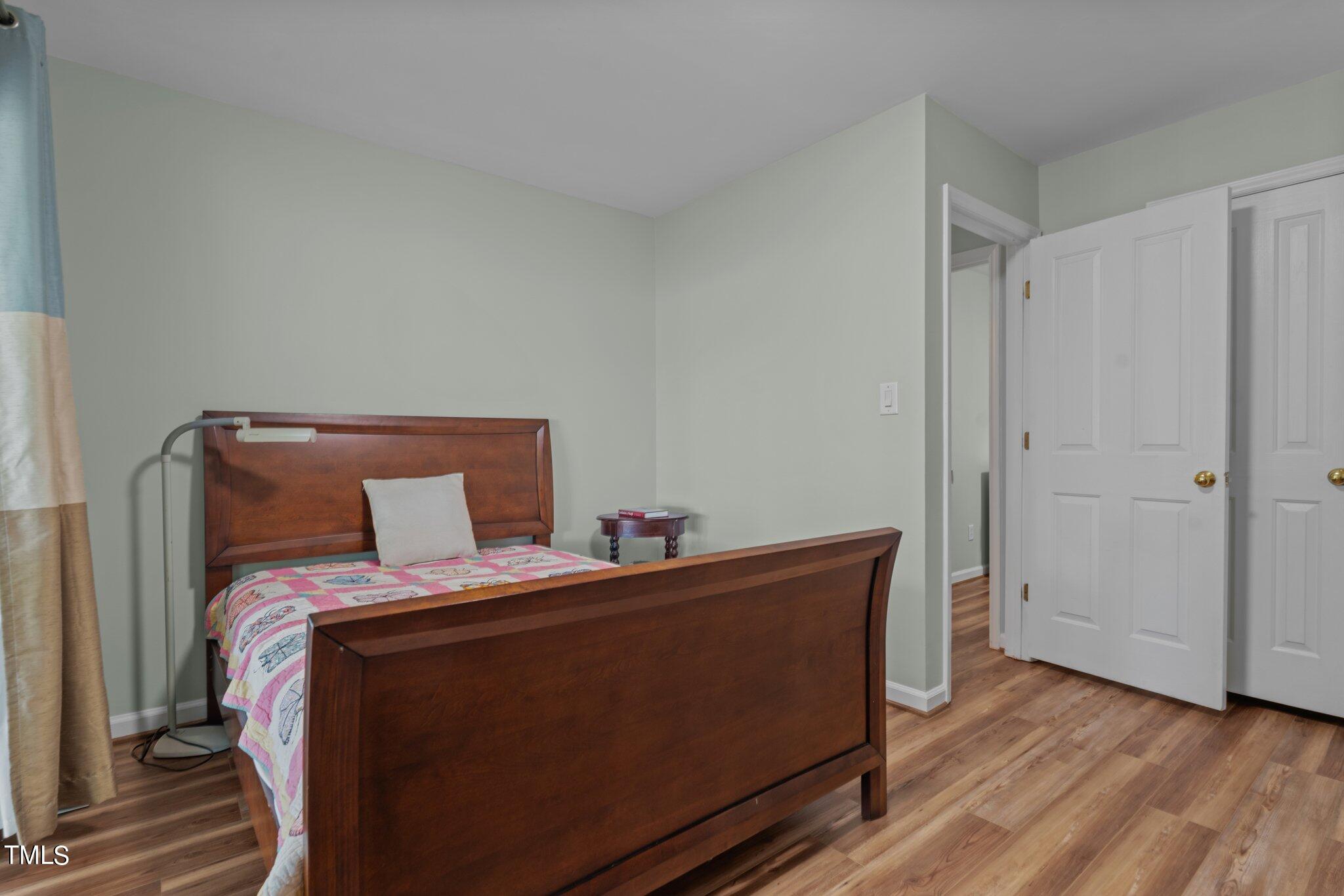 744 Alderman Mill Road Dunn, NC 28334 - Photo 31 of 50 a bed sitting in a bedroom next to a cabinet