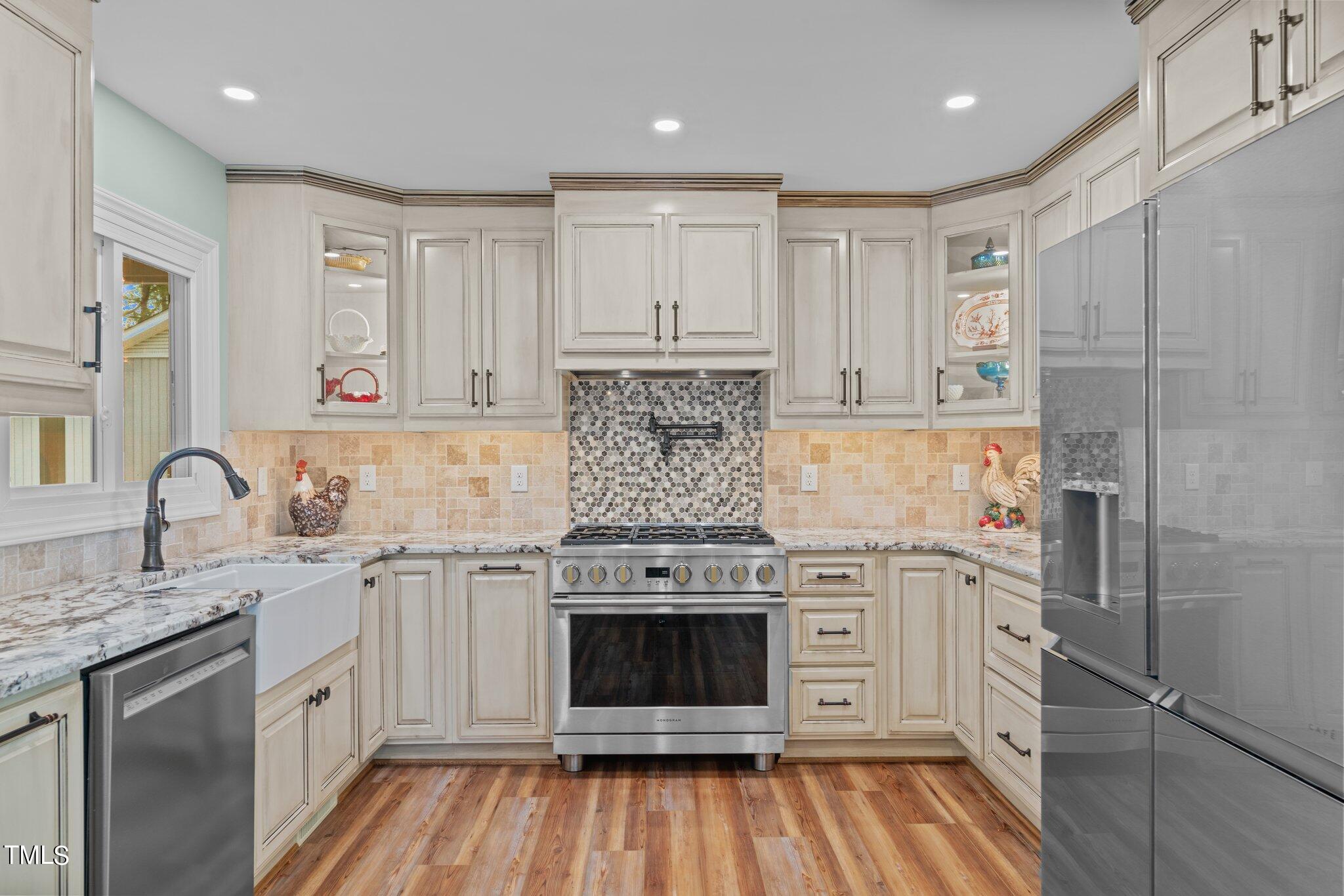 744 Alderman Mill Road Dunn, NC 28334 - Photo 6 of 50 a kitchen with stainless steel appliances granite countertop a stove and a refrigerator