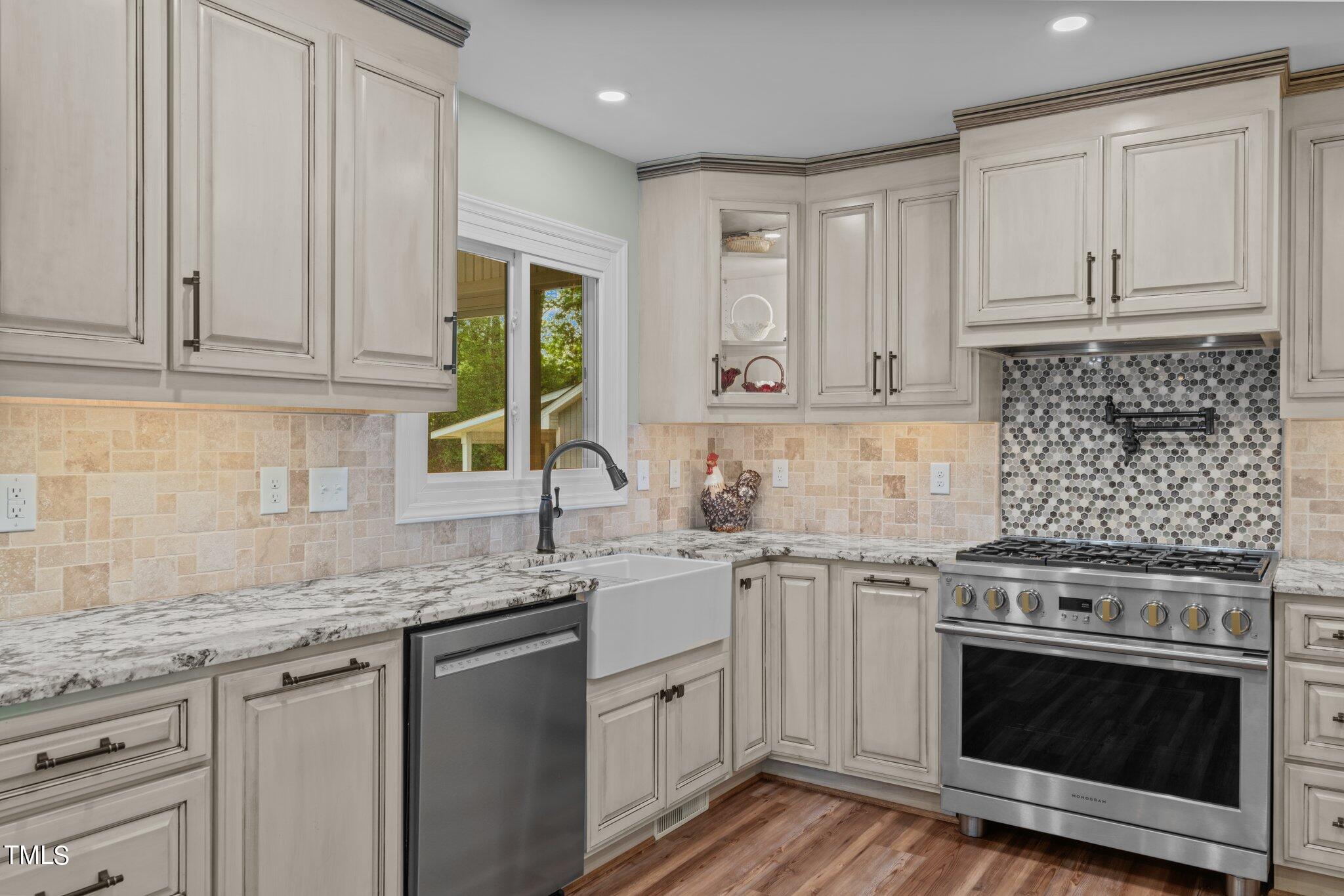 744 Alderman Mill Road Dunn, NC 28334 - Photo 7 of 50 a kitchen with granite countertop stainless steel appliances white cabinets granite counter tops and a wooden floors
