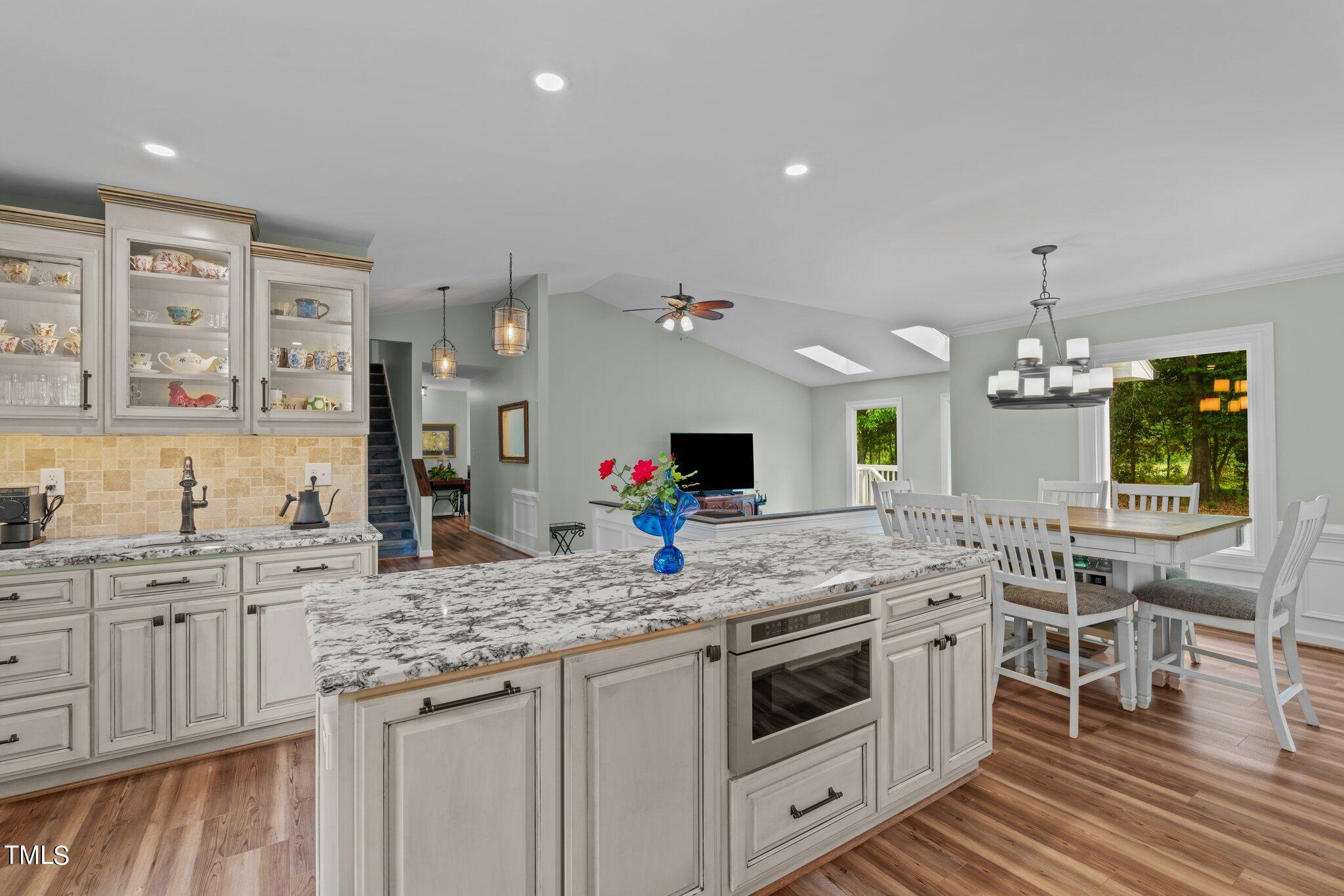 744 Alderman Mill Road Dunn, NC 28334 - Photo 9 of 50 a kitchen with stainless steel appliances granite countertop a sink and cabinets