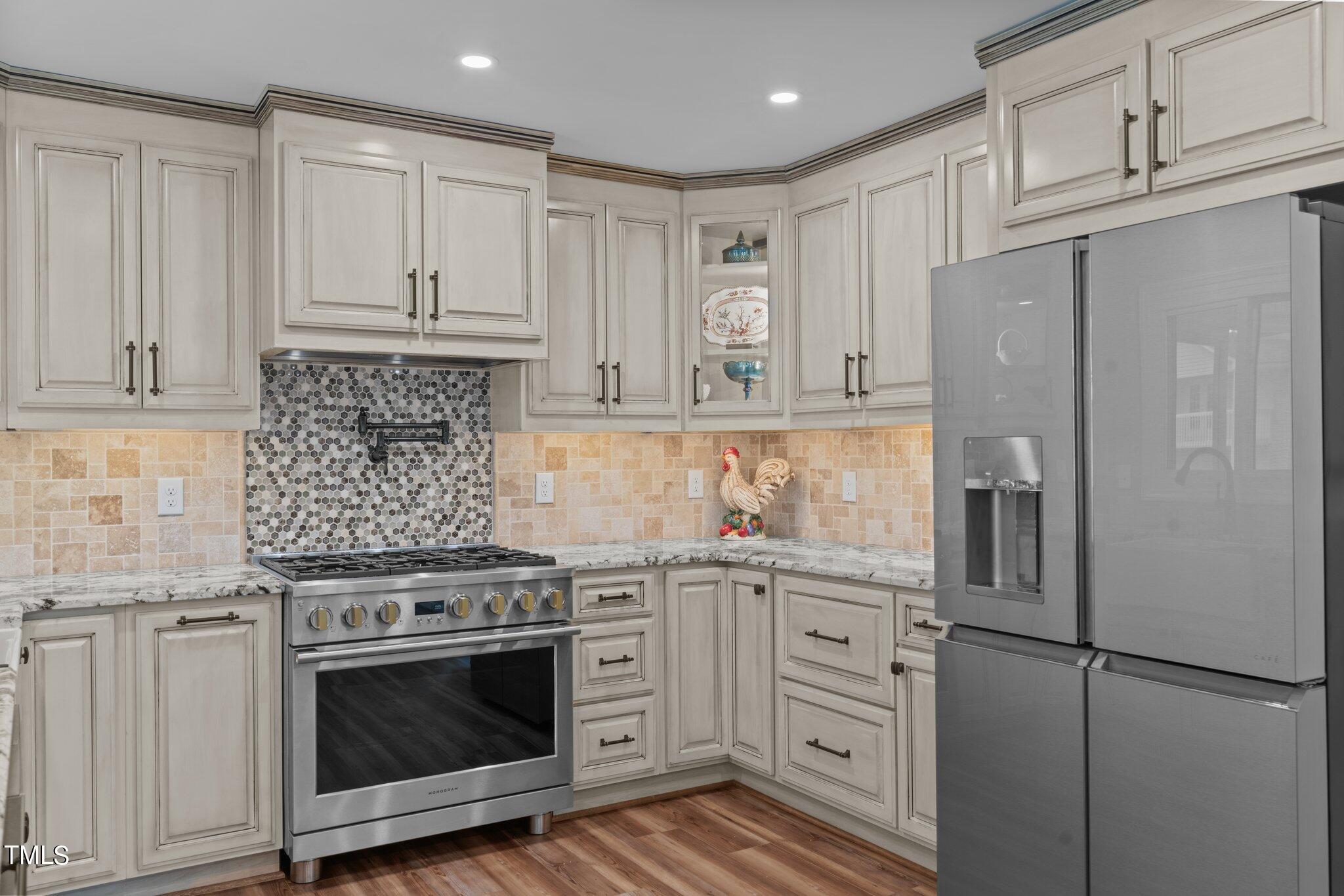 744 Alderman Mill Road Dunn, NC 28334 - Photo 10 of 50 a kitchen with cabinets stainless steel appliances and wooden floor