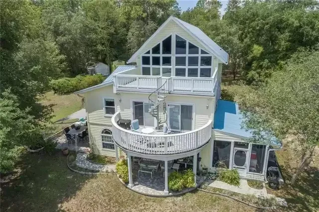 a view of a house with yard and entertaining space
