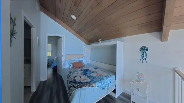 a bedroom with a bed and a potted plant