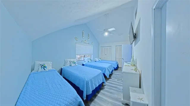 a bedroom with two beds and a table