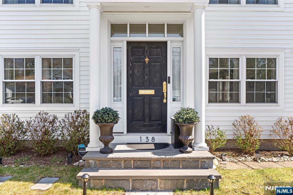 138 Brookside Avenue Cresskill, NJ 07626 - Photo 3 of 6 a front view of a house with potted plants