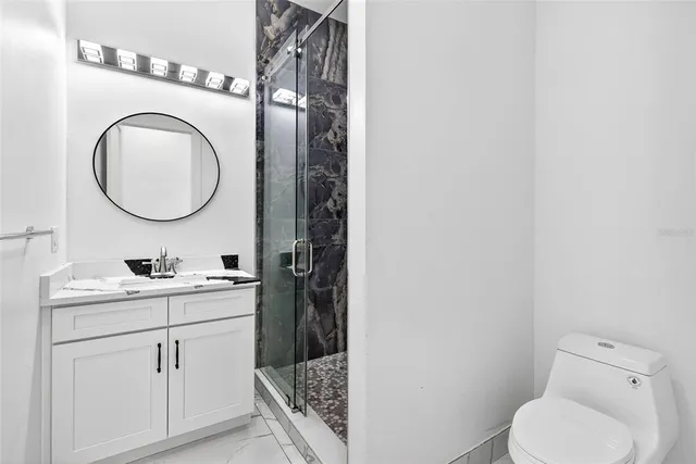 a bathroom with a shower and mirror