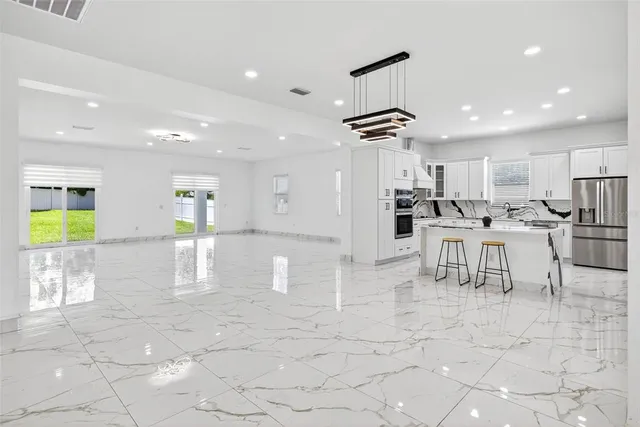 a kitchen with stainless steel appliances granite countertop a sink and a stove