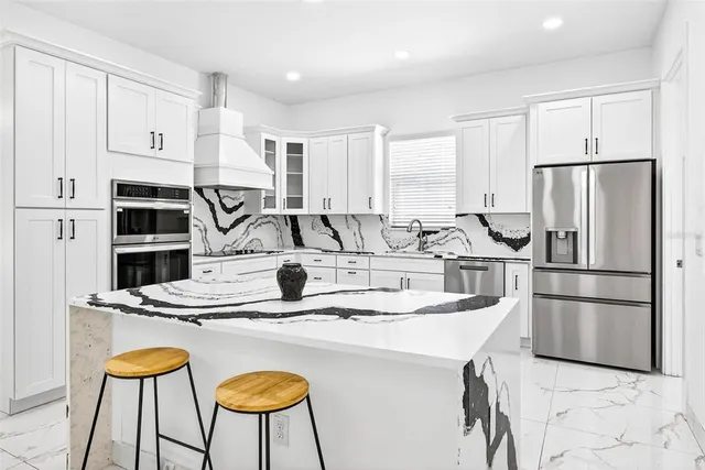 a kitchen with white cabinets and a stove