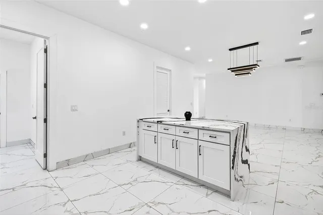 a view of an empty room and a window