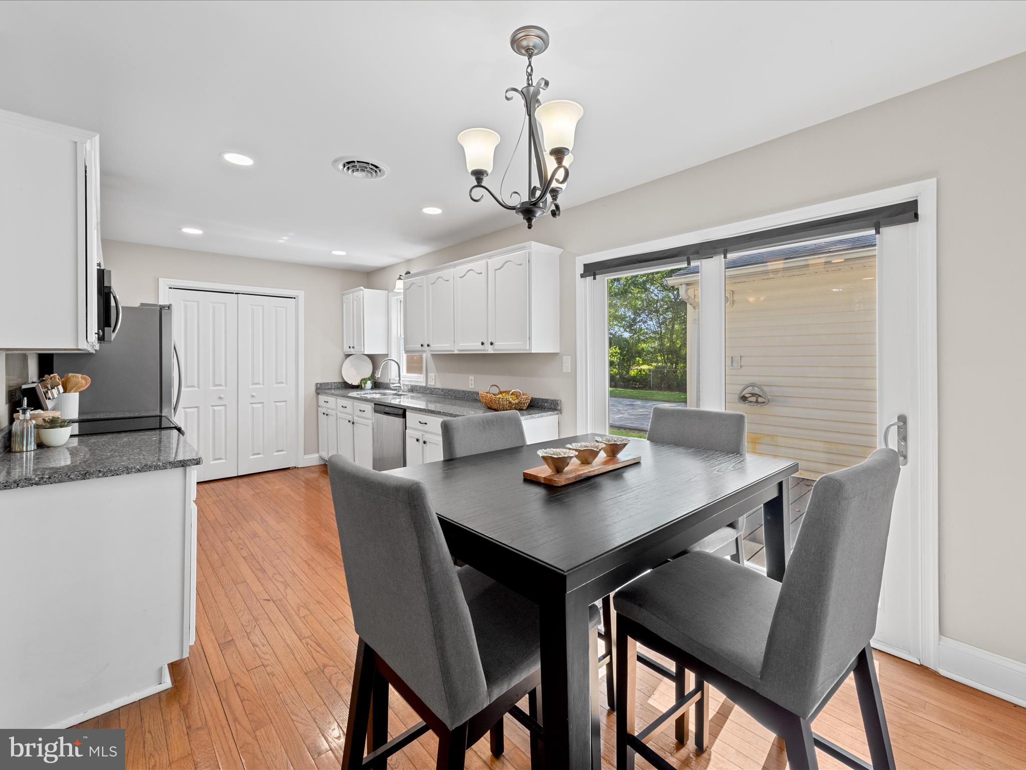 26831 River Road Seaford, DE 19973 - Photo 10 of 41 a view of a dining room with furniture window and wooden floor