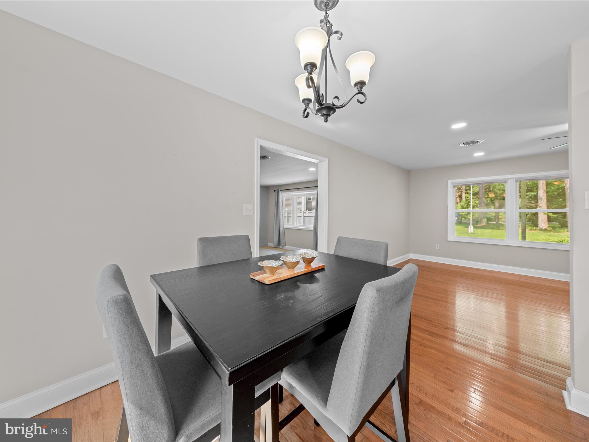 26831 River Road Seaford, DE 19973 - Photo 12 of 41 a view of a dining room with furniture wooden floor and chandelier