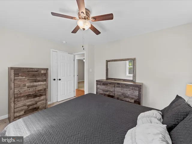 a bedroom with a bed and dresser