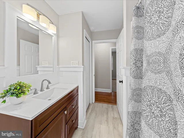 a bathroom with a sink toilet and a mirror