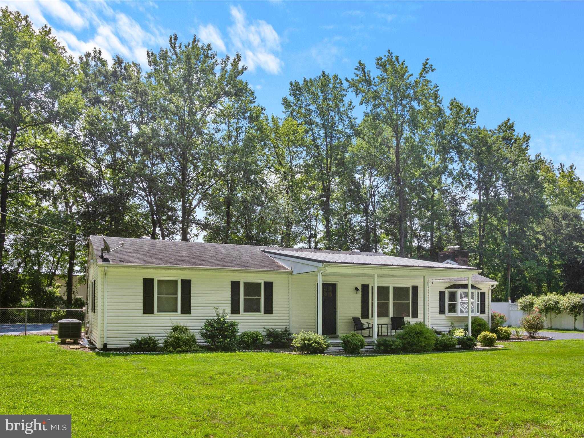 26831 River Road Seaford, DE 19973 - Photo 3 of 41 a front view of a house with a garden and trees