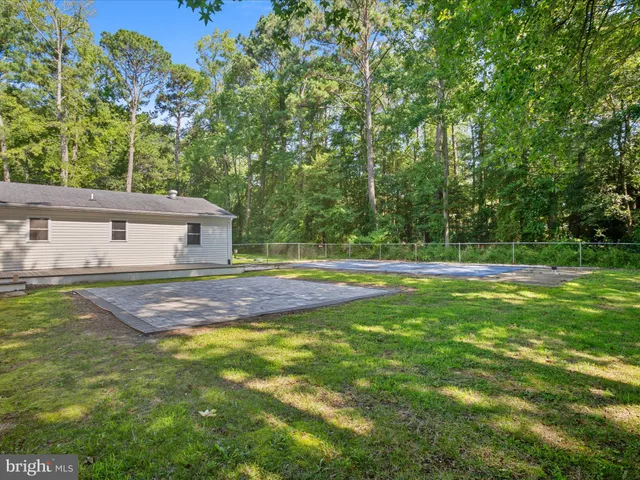 a view of pool with trees in the background