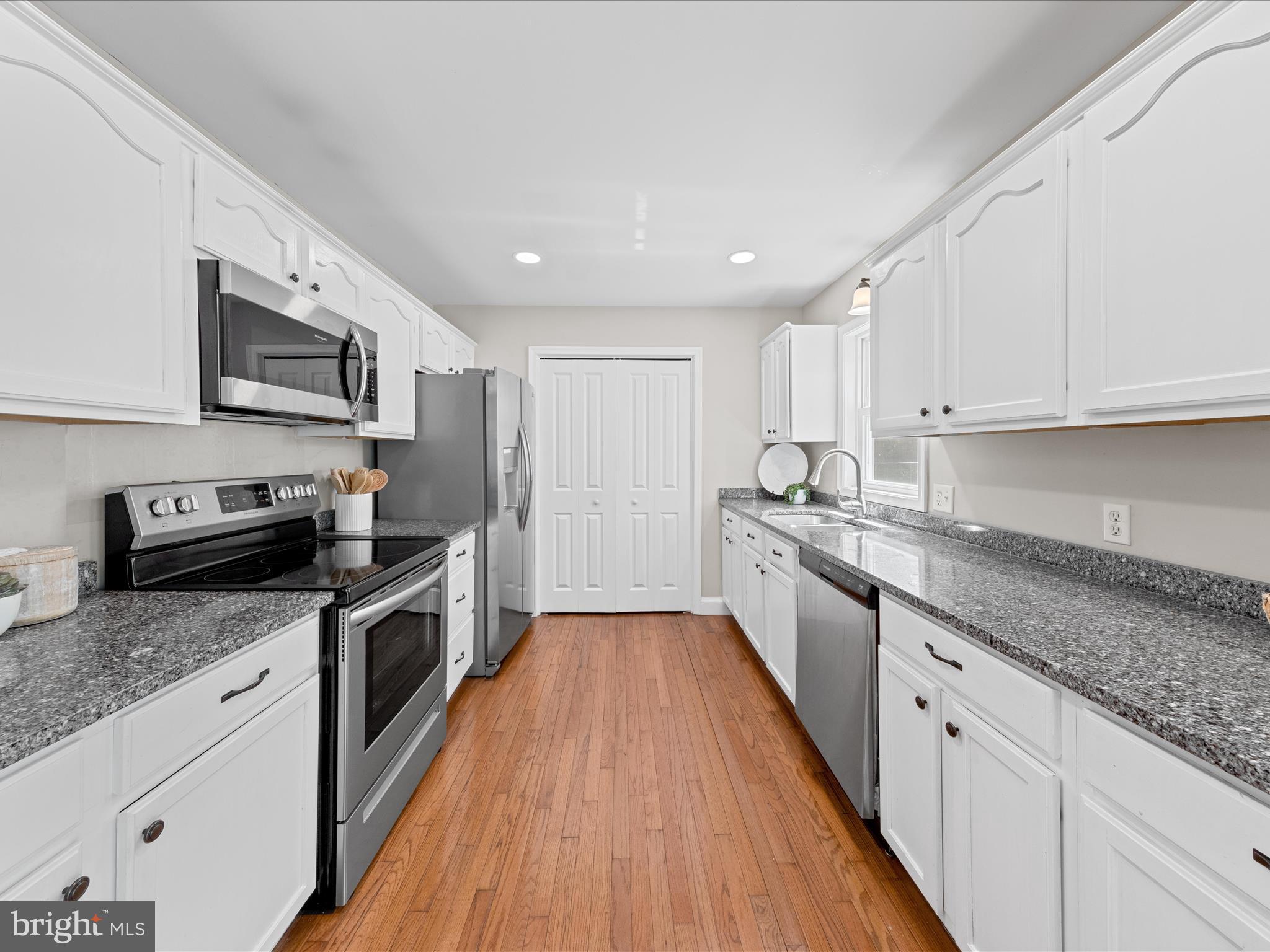 26831 River Road Seaford, DE 19973 - Photo 6 of 41 a large kitchen with stainless steel appliances granite countertop a stove sink and cabinets