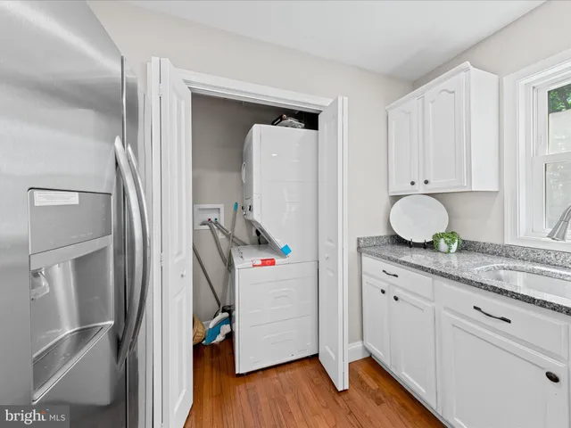 a room with wooden floor and cabinets