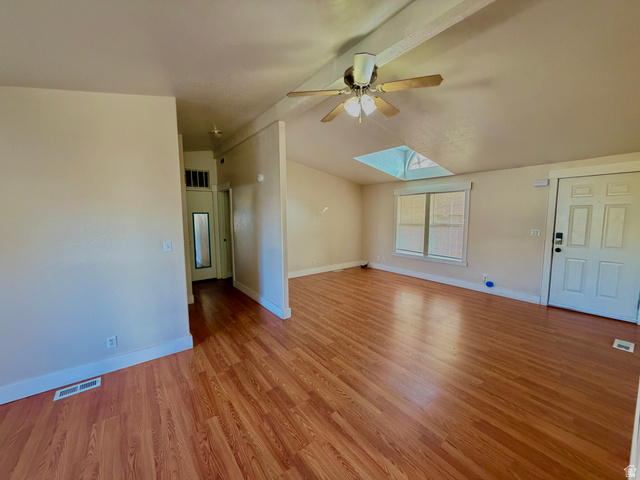 1025 North 300 West, Unit 1 Springville, UT 84663 - Photo 7 of 35 Unfurnished living room with a skylight, vaulted ceiling, light wood finished floors, and ceiling fan