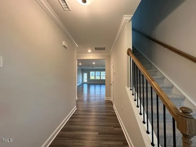 a view of a hallway with wooden floor and staircase