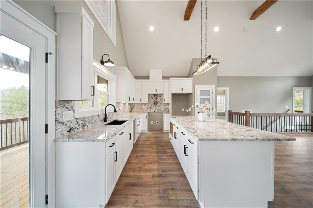 2956 Blalock Mountain Road Talking Rock, GA 30175 - Photo 17 of 63 a large kitchen with stainless steel appliances kitchen island a large counter tops and white cabinets