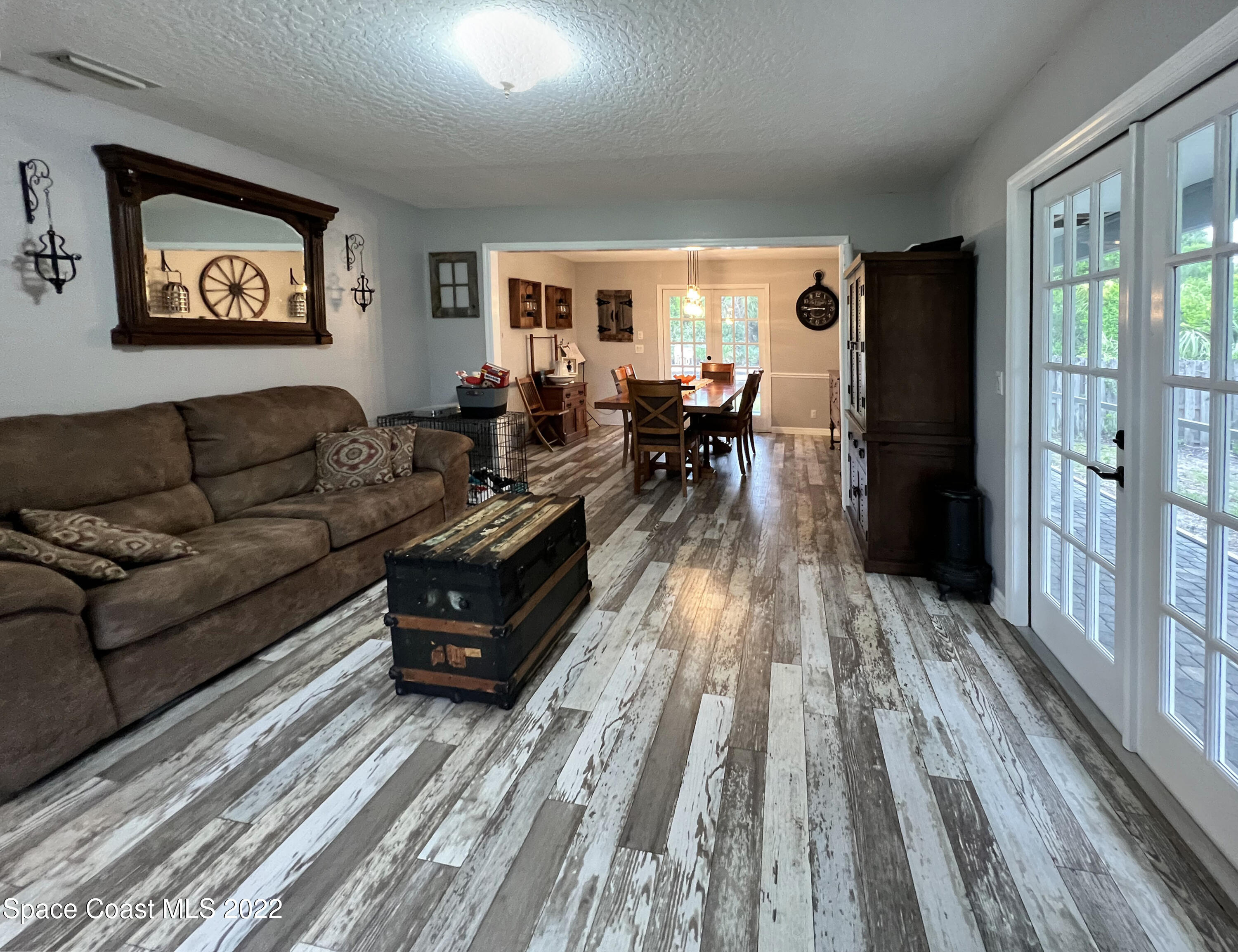 4030 Sparrow Hawk Road Melbourne, FL 32934 - Photo 16 of 46 a living room with furniture and a wooden floor