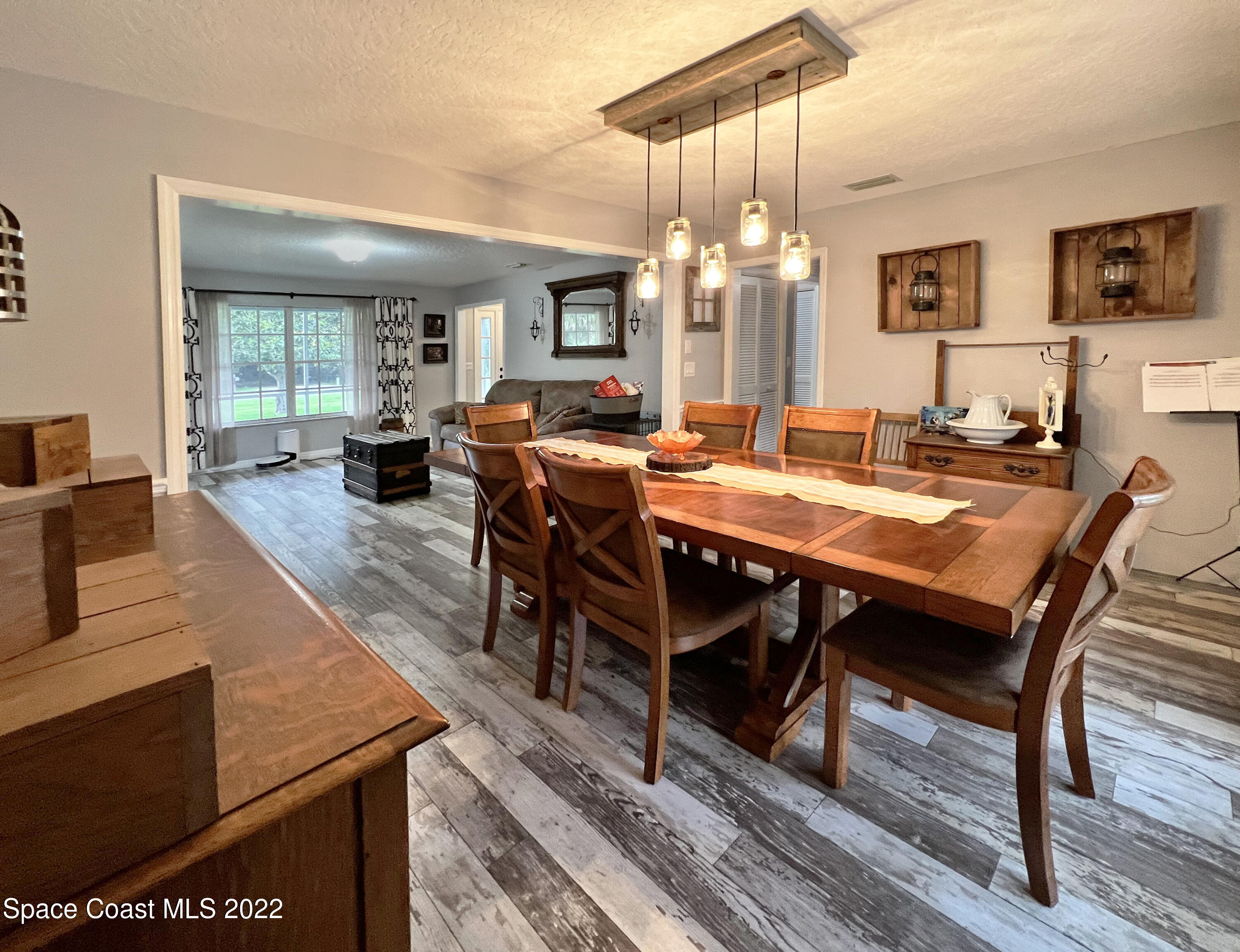4030 Sparrow Hawk Road Melbourne, FL 32934 - Photo 18 of 46 a view of a dining room with furniture window and wooden floor