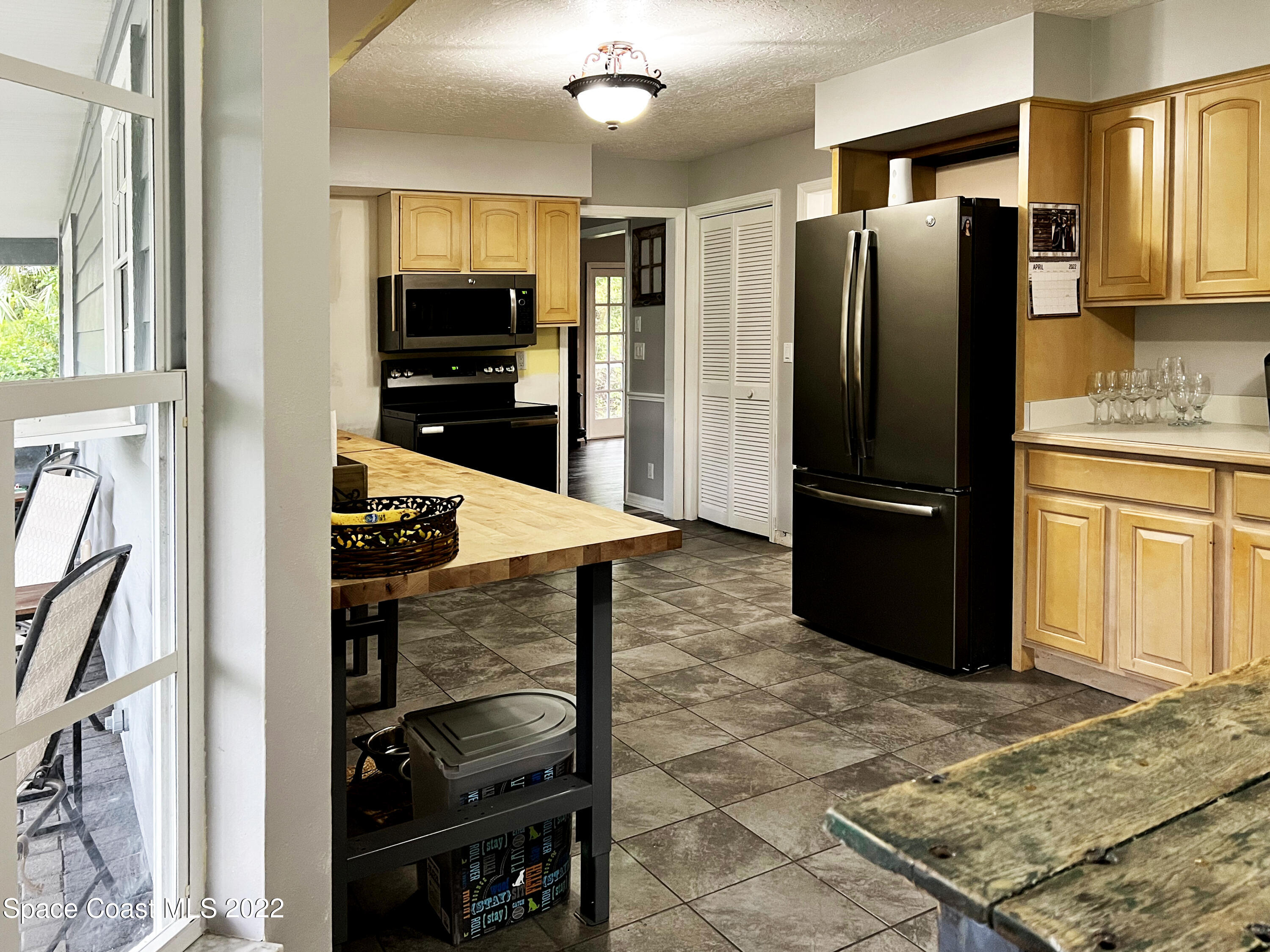 4030 Sparrow Hawk Road Melbourne, FL 32934 - Photo 24 of 46 a kitchen with a refrigerator and a stove top oven