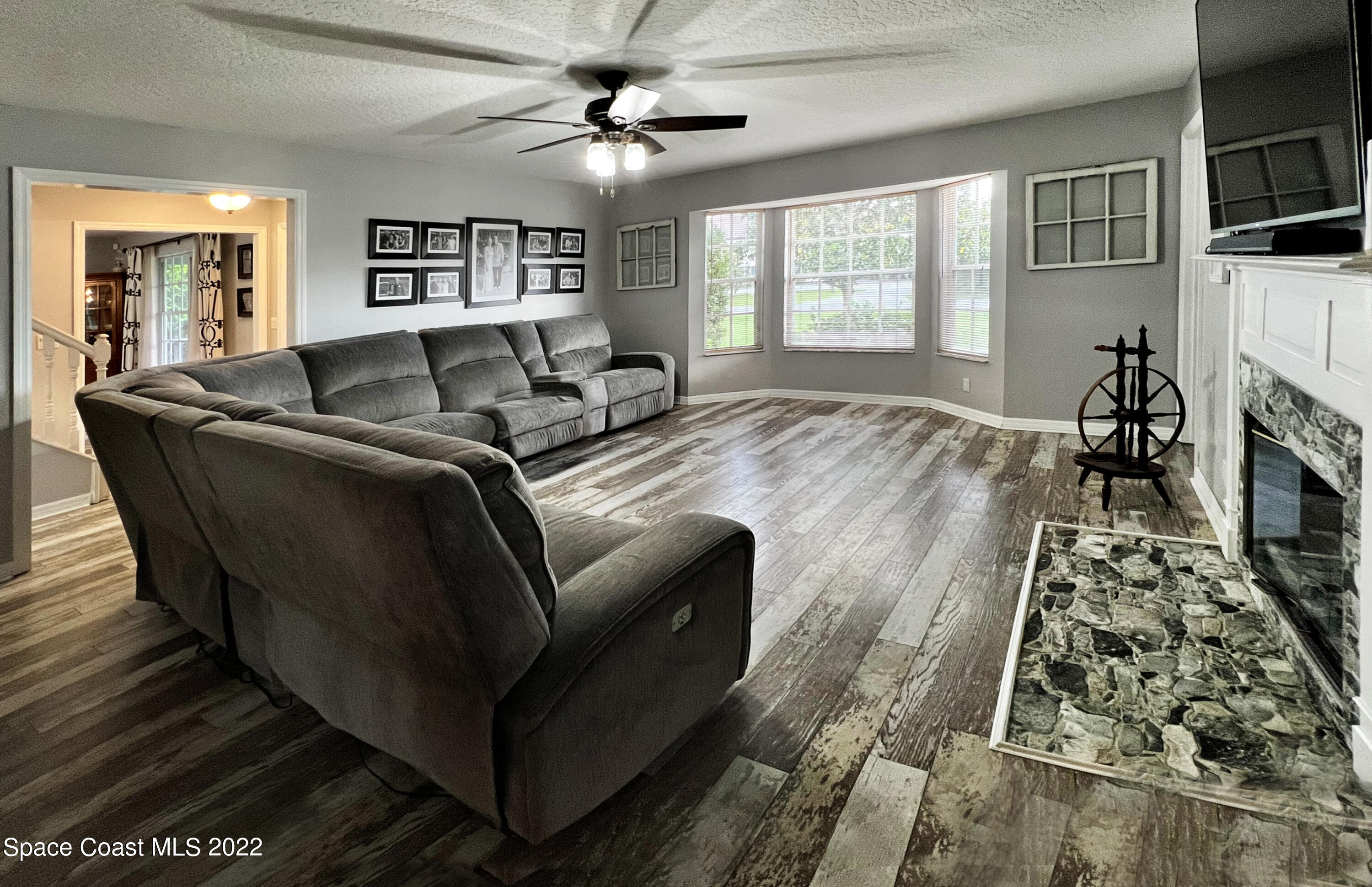 4030 Sparrow Hawk Road Melbourne, FL 32934 - Photo 26 of 46 a living room with furniture and a fireplace