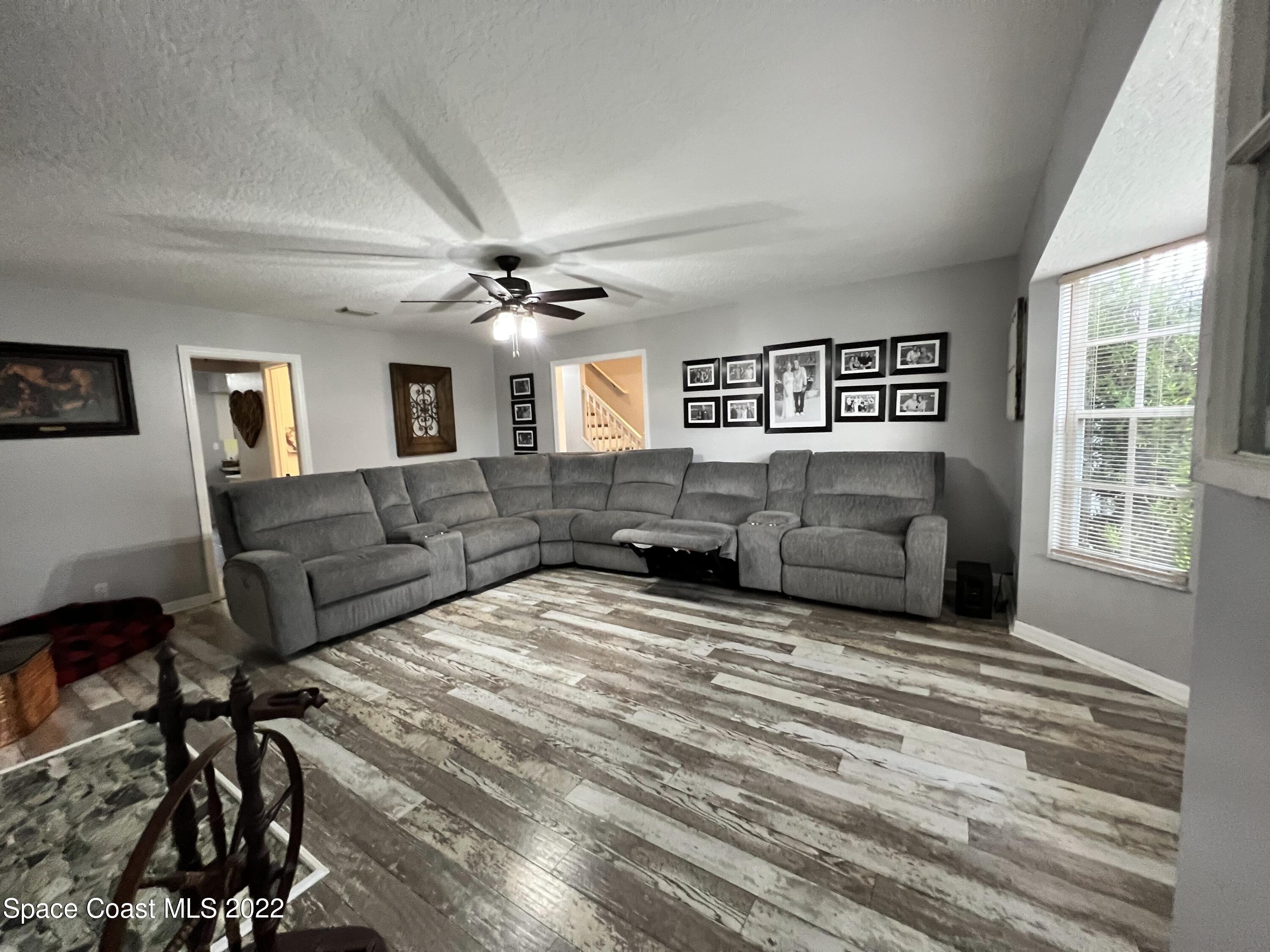 4030 Sparrow Hawk Road Melbourne, FL 32934 - Photo 27 of 46 a living room with furniture and a large window