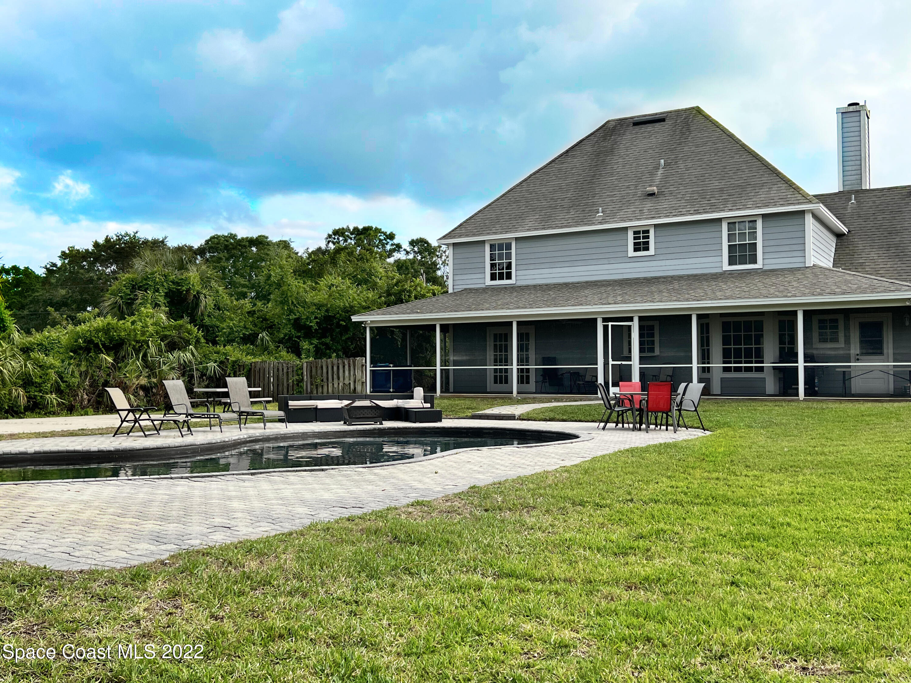 4030 Sparrow Hawk Road Melbourne, FL 32934 - Photo 5 of 46 a front view of a house with a yard and trees