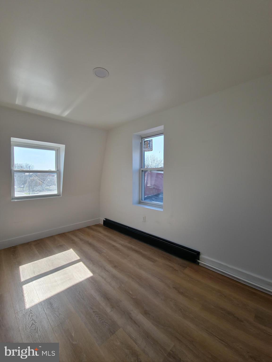100 Neversink Street Reading, PA 19602 - Photo 27 of 35 an empty room with wooden floor and windows