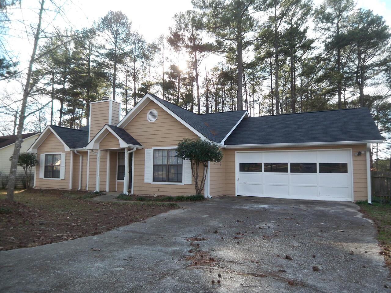10367 Candlelight Road Jonesboro, GA 30238 - Photo 1 of 1 a front view of a house with a yard and garage