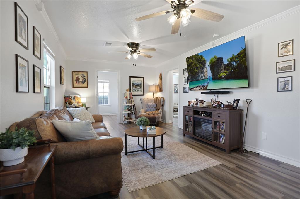 271 East Houston Street Van Alstyne, TX 75495 - Photo 11 of 40 a living room with furniture and a flat screen tv