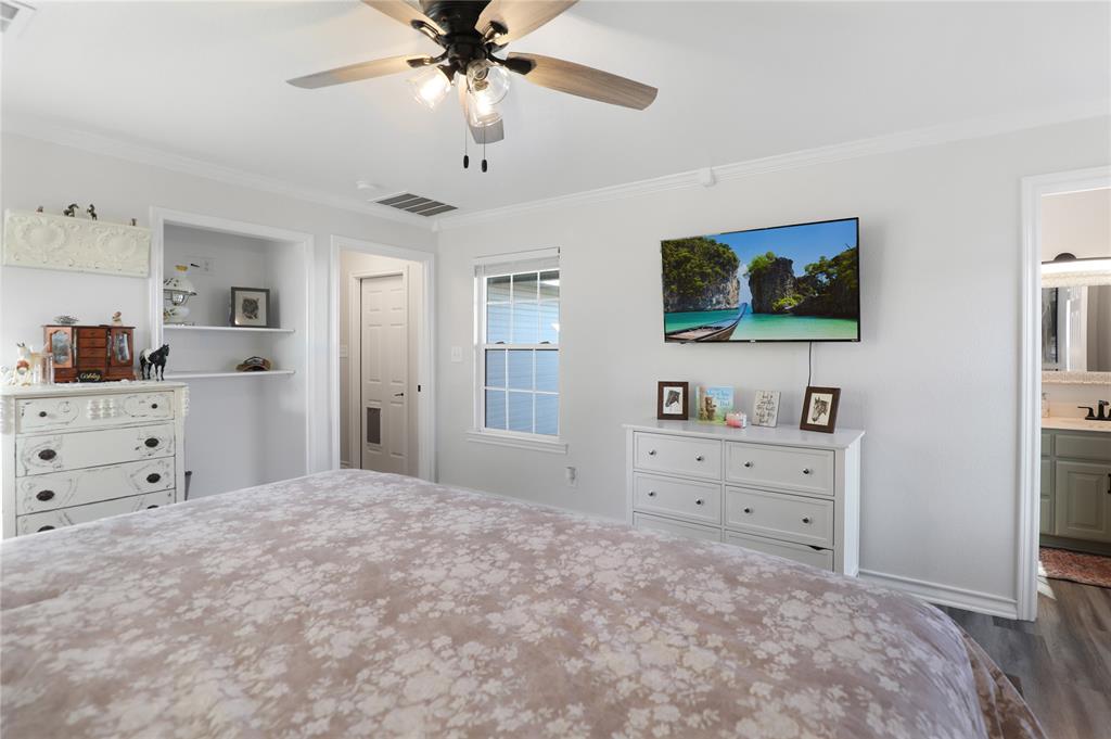 271 East Houston Street Van Alstyne, TX 75495 - Photo 19 of 40 a bedroom with a bed and a flat screen tv