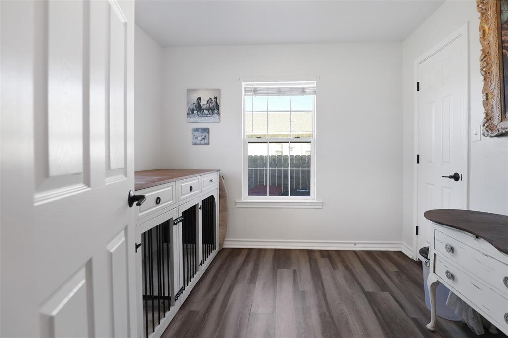 271 East Houston Street Van Alstyne, TX 75495 - Photo 22 of 40 a kitchen with wooden floors and sink
