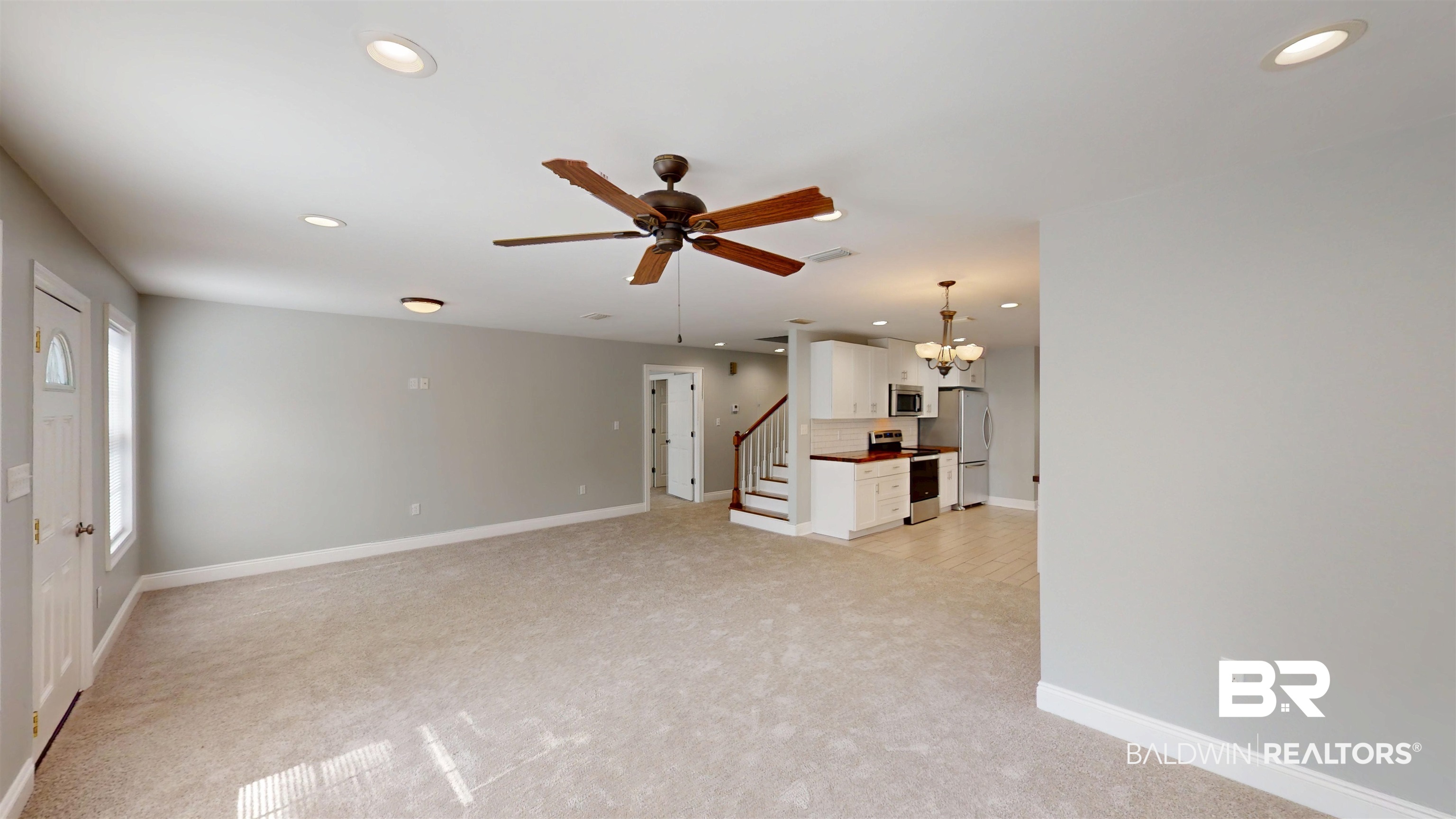 2454 Taylor Avenue Mobile, AL 36606 - Photo 6 of 24 Unfurnished living room featuring light colored carpet, a ceiling fan, and a chandelier
