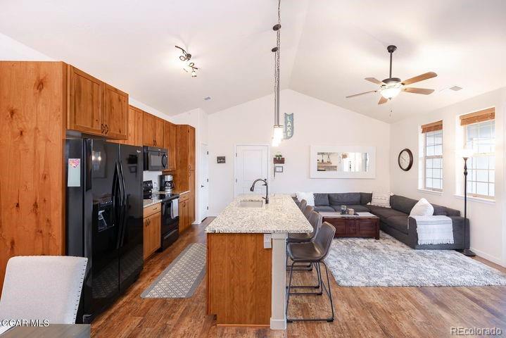 164 Village Road, Unit H304 Granby, CO 80446 - Photo 15 of 50 a living room with stainless steel appliances kitchen island granite countertop furniture and a chandelier