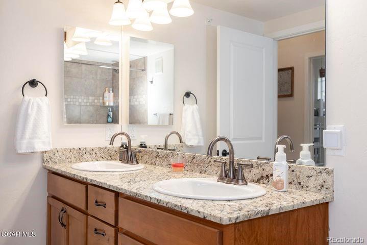 164 Village Road, Unit H304 Granby, CO 80446 - Photo 22 of 50 a bathroom with a granite countertop sink a mirror and a