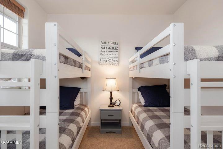 164 Village Road, Unit H304 Granby, CO 80446 - Photo 23 of 50 a spacious bedroom with a bed and a fireplace