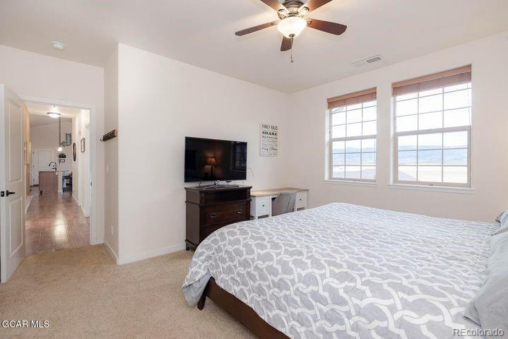 164 Village Road, Unit H304 Granby, CO 80446 - Photo 27 of 50 a bedroom with a bed and a flat screen tv