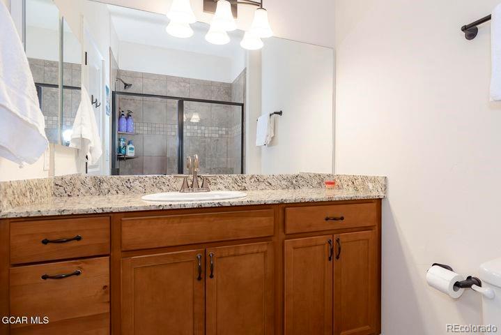 164 Village Road, Unit H304 Granby, CO 80446 - Photo 30 of 50 a bathroom with a granite countertop sink and a mirror