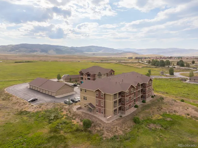 an aerial view of a house with outdoor space and ocean view