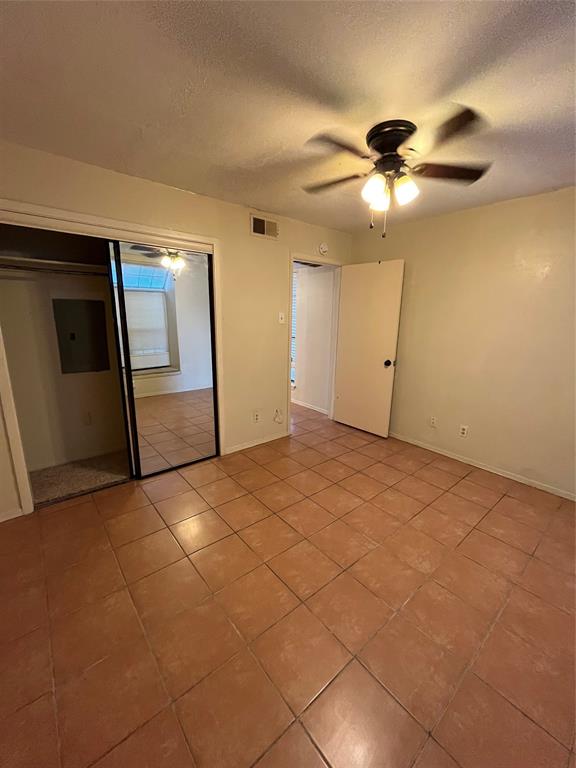 4460 Chaha Road, Unit 205 Garland, TX 75043 - Photo 16 of 27 a view of an empty room with window and chandelier fan
