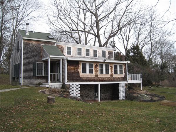 106 Indian Point Road Tiverton, RI 02878 - Photo 1 of 24 a front view of a house with a garden
