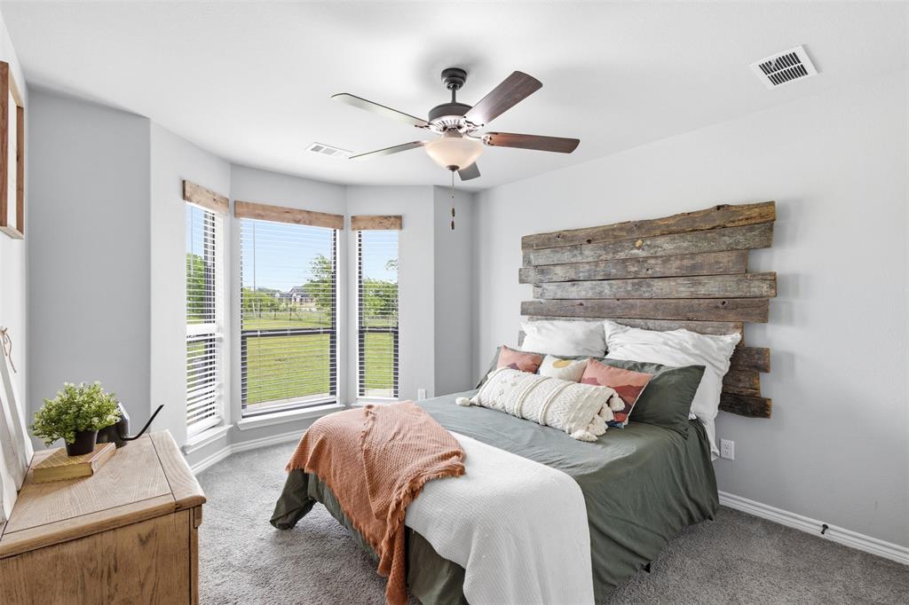 2990 Wilson Road Palmer, TX 75152 - Photo 23 of 40 a bedroom with a large bed and a chandelier