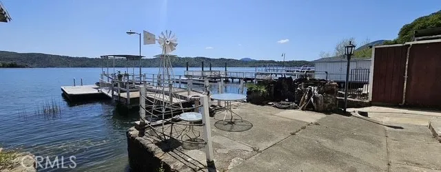 a view of a terrace with furniture and lake view
