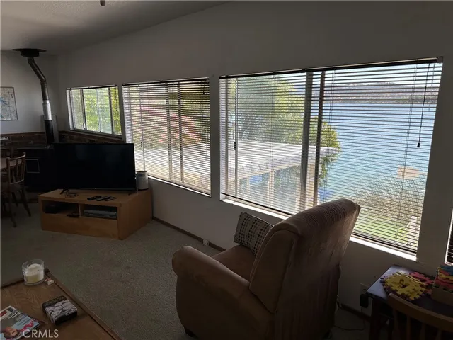 a view of a dining room with furniture large windows and wooden floor
